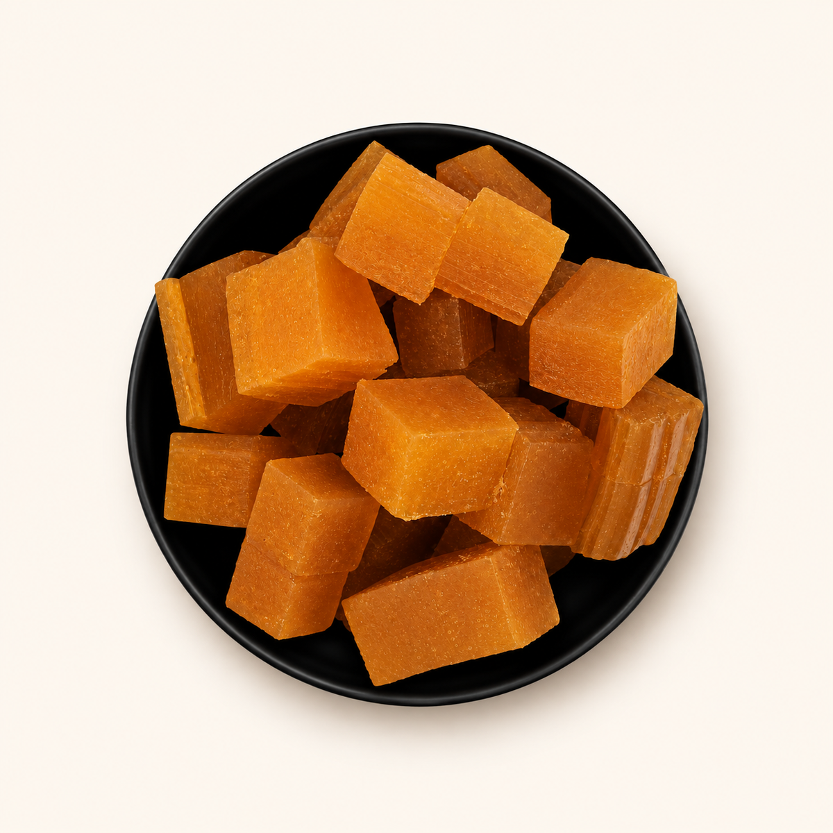 Aam Papad in a bowl on an off-white background