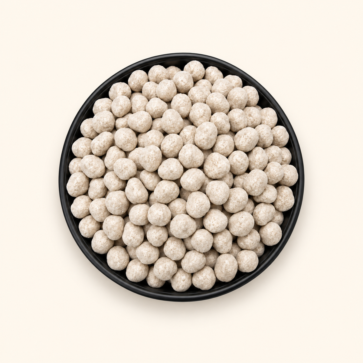 Anardana Goli in a bowl on an off-white background