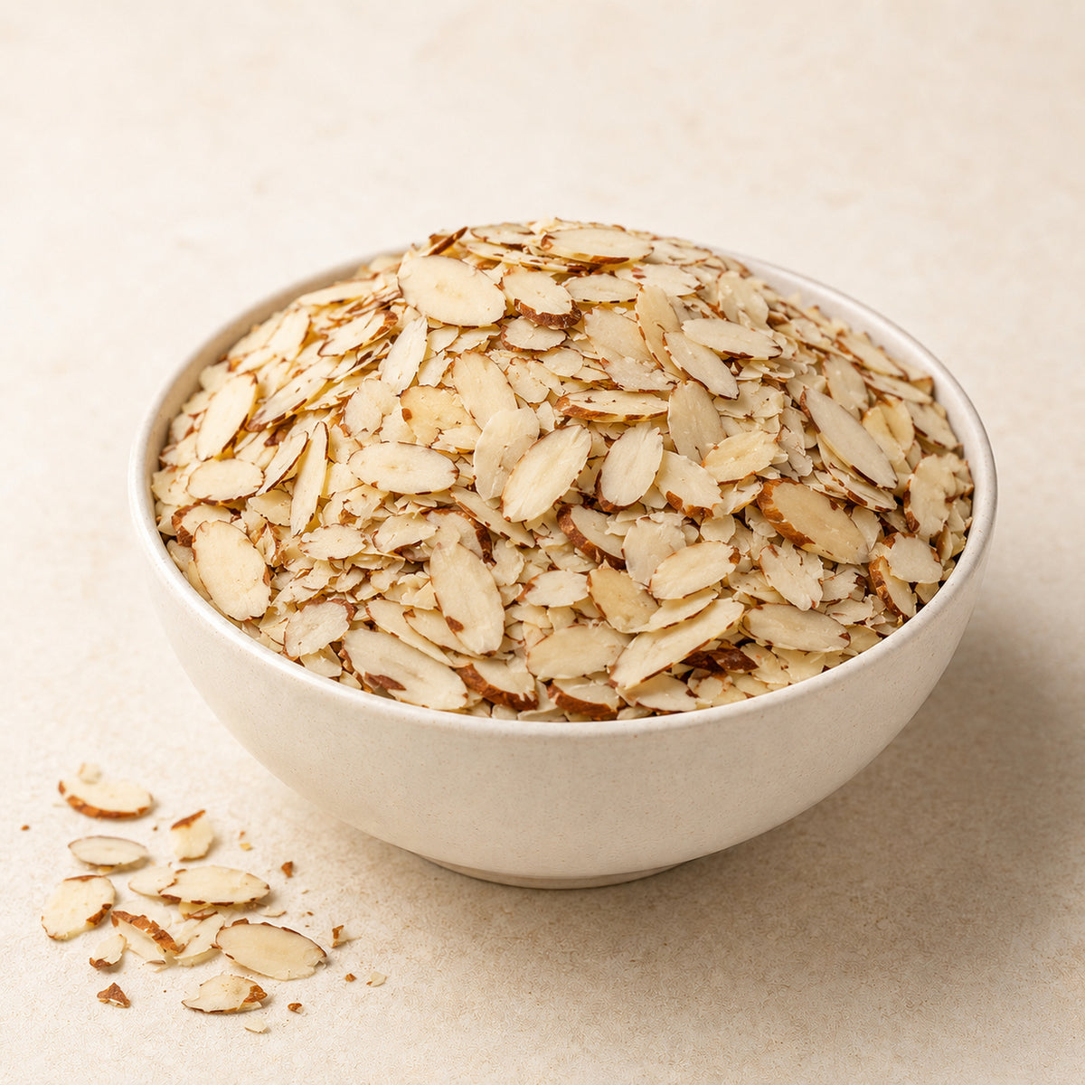 GovindJee Almond Flakes / Badam Cutting in a bowl on off-white background