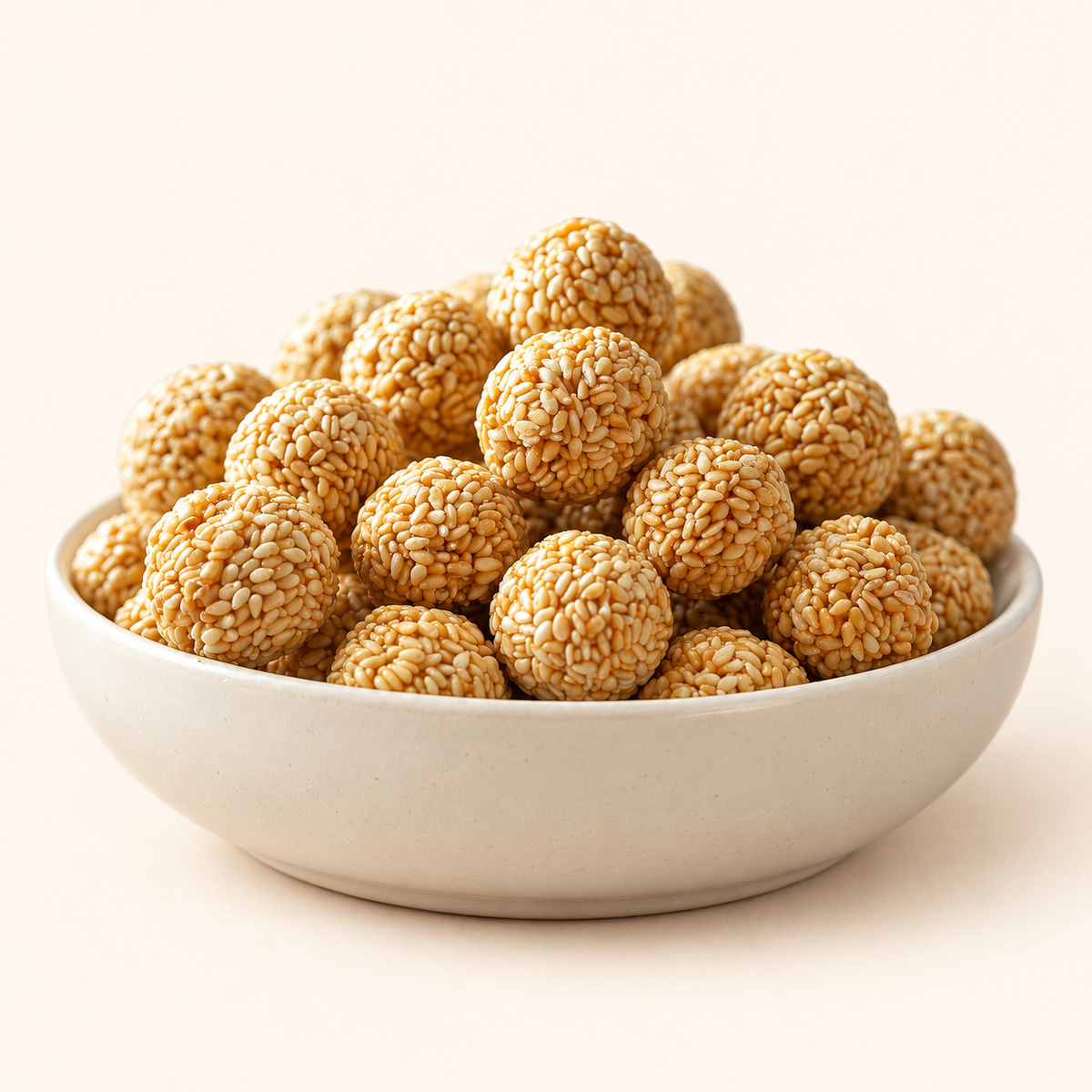 GovindJee Mini Til Ladoo in a bowl on warm cream background