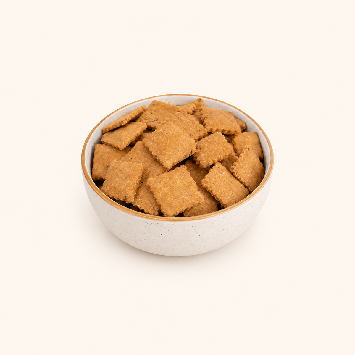 Salted whole wheat mathari in an ivory bowl on an off-white background